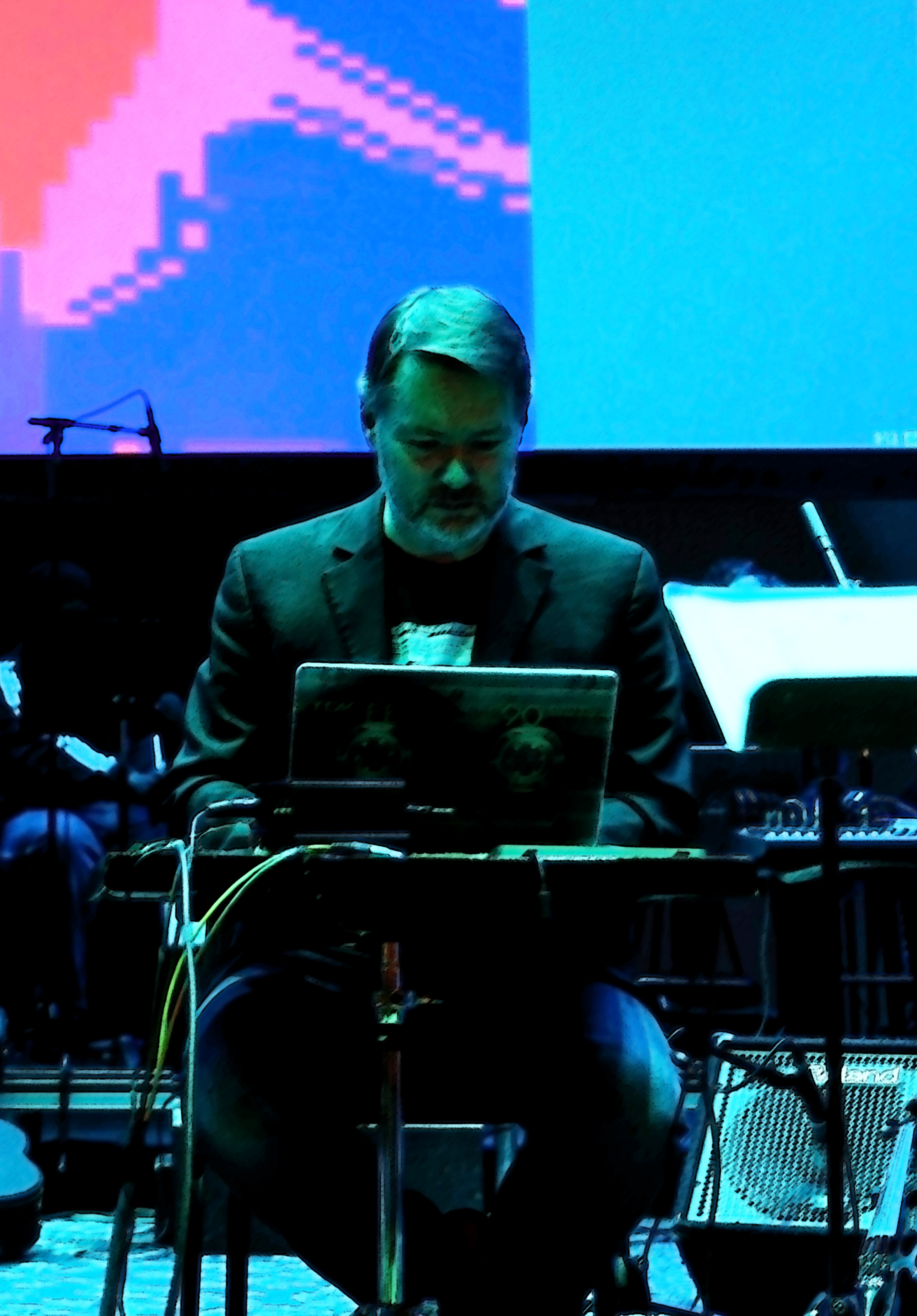 Eddie holding a trumpet outdoors with blurred mountains in the background